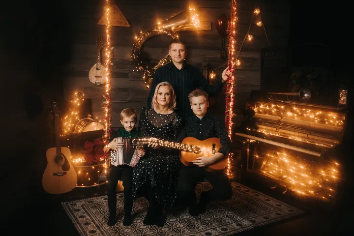 A family among a piano, instruments and warm lights
